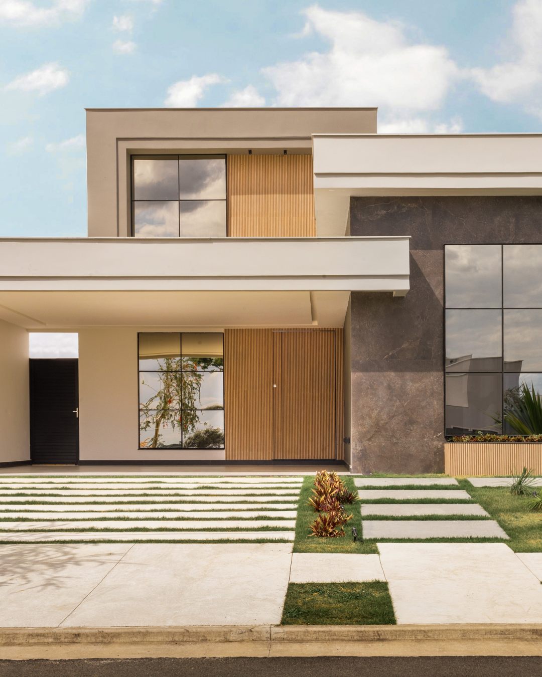 Contemporary residence with wood-slat entry and stone facade.
